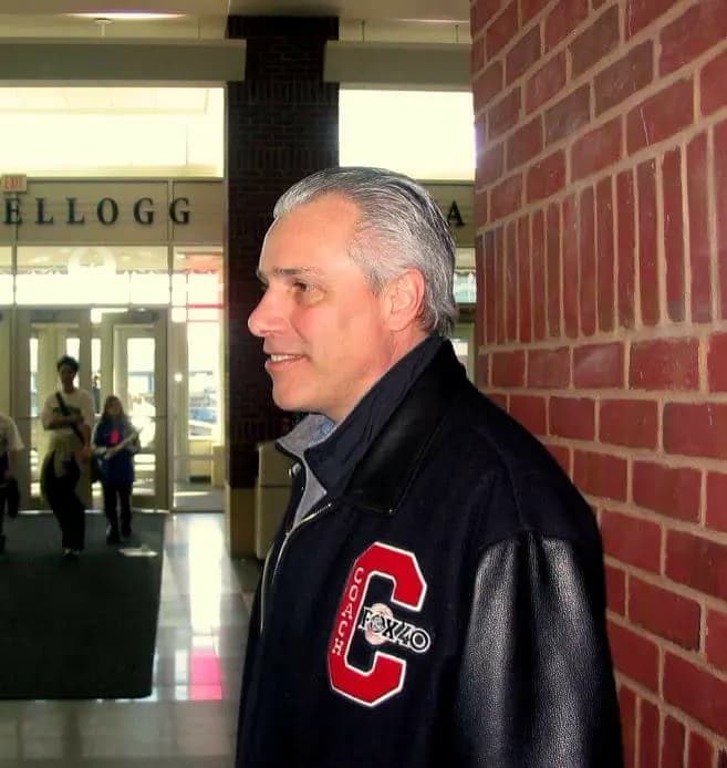 Mike Schwartz in his COACH letter jacket in a Minnesota high school corridor