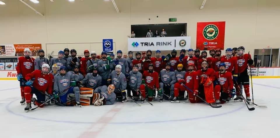 Players and coaches gathered at center ice at TRIA Rink after an on-ice session